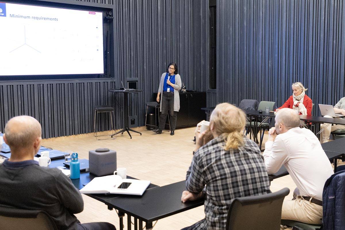 A person holding a presentation in a conference setting.