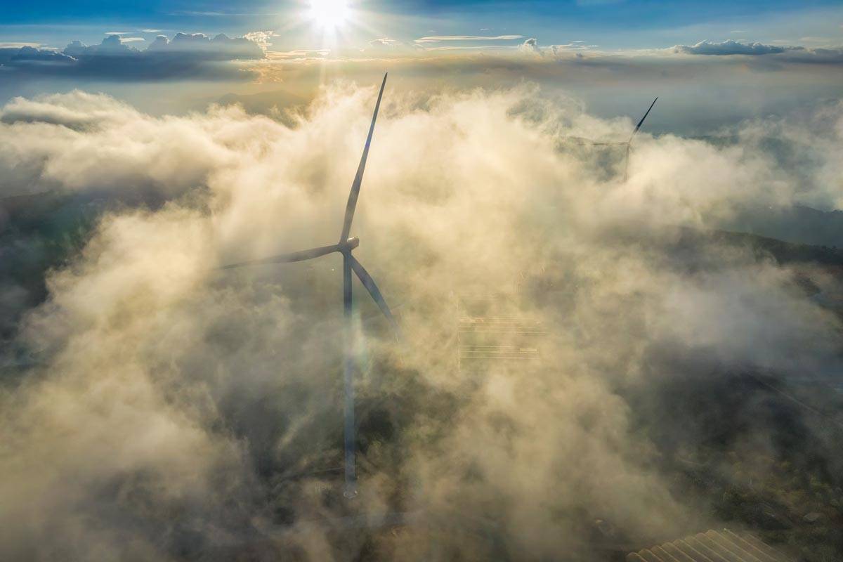 Aerial view of wind turbines in the fog.